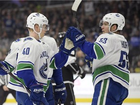 Vancouver Canucks center Elias Pettersson, left, celebrates his goal with center Bo Horvat during the first period of an NHL hockey game against the Los Angeles Kings Thursday, Feb. 14, 2019, in Los Angeles.