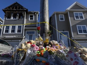 A memorial of flowers and stuffed animal toys is seen outside the scene of a fatal house fire in the Spryfield community in Halifax on Wednesday, February 20, 2019. The early-morning fire claimed the lives of seven Syrian refugee children and left the surviving mother and father in hospital.