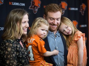 B.C. Lions quarterback Travis Lulay stands with his wife Kim as he holds two of their three daughters Jade, second left, 3, and Everly, 4, after a news conference after announcing he was retiring from playing CFL football, in Surrey, B.C., on Thursday February 28, 2019.