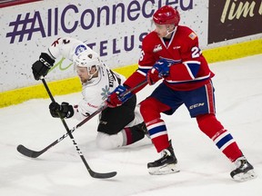 Vancouver Giants defenceman Dallas Hines is tripped by Spokane Chiefs centre Jack Finley, earning Finley a minor penalty in the first period of a regular season WHL game at the LEC on Friday.