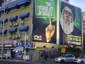 A billboard shows Hezbollah militant leader Hassan Nasrallah above a major highway in Tel Aviv, Israel, Sunday, Feb. 10, 2019, as the face of a satirical eye-catching, plastic bottle recycling campaign. (AP Photo/Ariel Schalit)