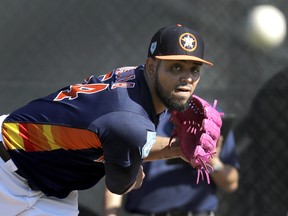 Houston Astros pitcher Roberto Osuna throws a bullpen session during spring training Friday, Feb. 15, 2019, in West Palm Beach, Fla. (AP Photo/Jeff Roberson)