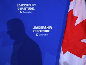 Former Prime Minister Stephen Harper's shadow is cast upon his Conservative party's moniker at the Canadian Club at Toronto's Sheraton Centre on Tuesday Oct. 7, 2008.