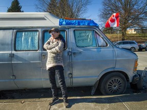 Melinda Bergstron stands outside the home-on-wheels she shares with her partner of 10 years. It's the second winter the couple has spent in the van.