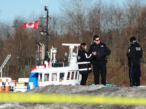 Independent Investigation Officers (IIO) and New Westminster police investigate after officers were called to a report of a suicidal man, possibly carrying a firearm, at the rear of a Walmart store in the Queensborough neighbourhood, in New Westminster, BC., February 25, 2019.  Shots were fired as officers arrived and the man died of his injuries.