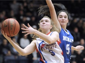 Brookswood Bobcats' Quinn Jasper has her eyes on the basket in front of  R.A. McMath Wildcats' Marina Radocaj during Wednesday's triple-A girls' basketball championship at the Langley Events Centre.