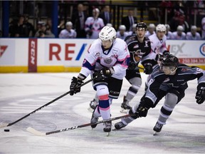 D-Jay Jerome of the Victoria Royals tries to wheel away from the checking of Davis Koch of the Vancouver Giants on Saturday in Victoria.