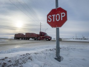 A truck goes through the intersection near the memorial for the 2018 crash where 16 people died and 13 injured when a truck collided with the Humboldt Broncos hockey team bus, at the crash site on Wednesday, January 30, 2019 in Tisdale, Sask. Saskatchewan's privacy commissioner has found eight people inappropriately accessed the electronic health records of ten Humboldt Broncos team members involved in the bus crash last April.