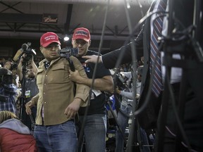 A Trump supporter, center, is restrained after he storms the media area, as journalists including BBC reporter Gary O’Donoghue, second left, work during a rally with U.S. President Donald Trump in El Paso, Texas, U.S., on Monday, Feb. 11, 2019.