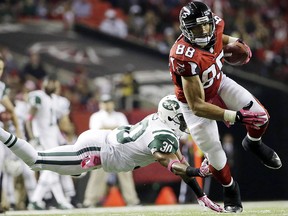 In this Oct. 7, 2013, file photo, Atlanta Falcons tight end Tony Gonzalez (88) moves the ball after a catch as New York Jets cornerback Darrin Walls (30) defends in Atlanta. (AP Photo/David Goldman, File)