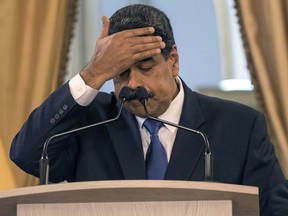 Venezuela's President Nicolas Maduro touches his forehead during a press conference at Miraflore's Presidential Palace in Caracas, Venezuela, Friday, Feb. 8, 2019.