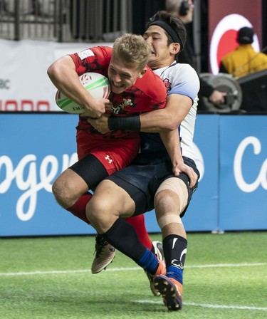 Yoshikazu Fujita of Japan tackles ball carrier Ethan Davies of Wales during rugby sevens action on Day 2 of the HSBC Canada Sevens at BC Place on Sunday, March 10, 2019 in Vancouver.