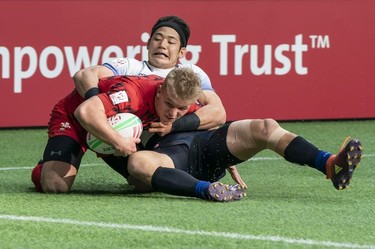 Yoshikazu Fujita #1 of Japan takes down ball carrier Ethan Davies of Wales during rugby sevens action on Day 2 of the HSBC Canada Sevens at BC Place on Sunday, March 10, 2019 in Vancouver.