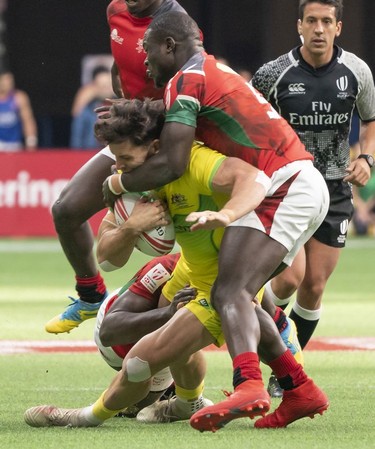 Simon Kennewell of Australia gets tacked by Bush Mwale of Kenya during rugby sevens action on Day 2 of the HSBC Canada Sevens at BC Place on Sunday, March 10, 2019 in Vancouver.