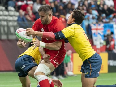 Admir Cejvanovic of Canada gets tacked by Alejandro Alonso and Pol Pla of Spain during rugby sevens action on Day 2 of the HSBC Canada Sevens at BC Place on Sunday, March 10, 2019.