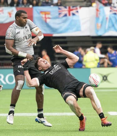 Sam Dickson of New Zealand reacts after getting tackled by Josua Vakurunabili of Fiji (left) during rugby sevens action on Day 2 of the HSBC Canada Sevens at BC Place on Sunday, March 10, 2019 in Vancouver.