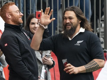 Actor Jason Momoa waves to fans while taking in the rugby sevens action on Day 2 of the HSBC Canada Sevens at BC Place on Sunday, March 10, 2019 in Vancouver.