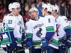 Alex Biega #55 (C) of the Vancouver Canucks talks with teammates Bo Horvat #53, Brock Boeser #6 and Nikolay Goldobin #77 during the second period of the NHL game against the Arizona Coyotes at Gila River Arena on February 28, 2019 in Glendale, Arizona.