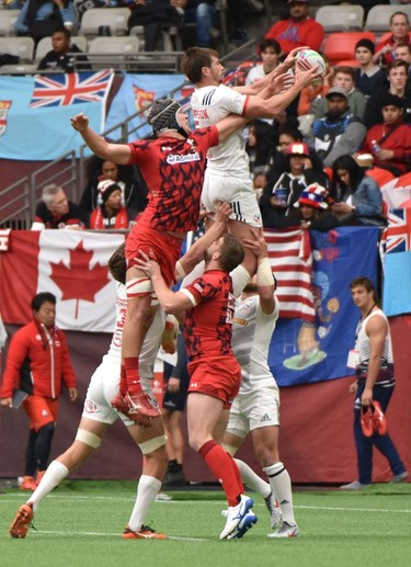 USA (white) and Wales(red) battle for the ball during World Rugby Sevens Series action in Vancouver, Canada, March 9, 2019.