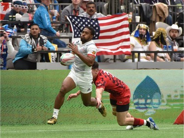 USAs Marcus Tupuola runs the ball to score a try against Wales during World Rugby Sevens Series action in Vancouver, Canada, March 9, 2019.