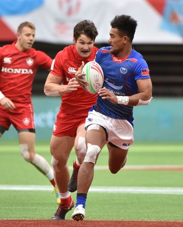 Samoa's Joe Perez carries the ball with Canada's Matt Mullins in pursuit during World Rugby Sevens Series action in Vancouver, Canada, March 9, 2019.