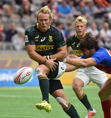 South Africa (green) and Chile (blue) battle for the ball during World Rugby Sevens Series action in Vancouver, BC, March 9, 2019.