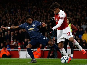 Manchester United midfielder Fred (left) battles with Arsenal striker Alex Iwobi during their English Premier League soccer match at the Emirates Stadium in London, U.K., on Sunday, March 10, 2019.