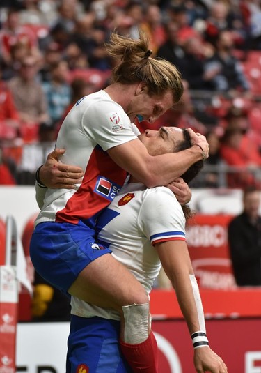 France's Stephen Parez-Edo jumps into the arms of Pierre Gilles Lakafiare after their 33-12 over Samoa during the World Rugby Sevens Series in Vancouver on Sunday, March 10, 2019.