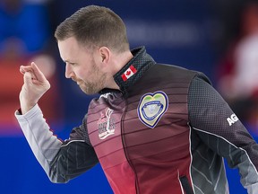 Team Canada skip Brad Gushue throws a piece of dirt that he believes threw off his rock in the second end during the Page Playoff 3 vs 4 game against Team Wild Card at the Brier in Brandon, Man. Saturday, March, 9, 2019. (THE CANADIAN PRESS/Jonathan Hayward)
