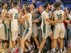 Lord Tweedsmuir celebrates their Quad A boys basketball win on Saturday