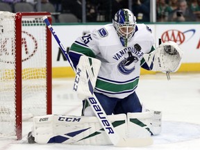 Jacob Markstrom blocks a shot against the Dallas Stars during a March 17, 2019 NHL game.