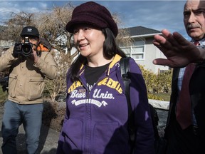 Huawei chief financial officer Meng Wanzhou, who is out on bail and remains under partial house arrest after being detained Dec. 1 at the behest of U.S. authorities, is accompanied by a private security detail as she leaves her home to attend a court appearance in Vancouver, on Wednesday, March 6, 2019.