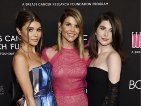 Actress Lori Loughlin (centre) will be allowed to return to Vancouver to complete her contracted work on various Hallmark Channel projects. Pictured with her are daughters Olivia Jade Giannulli, left, and Isabella Rose Giannulli at the 2019 “An Unforgettable Evening” in Beverly Hills, Calif.