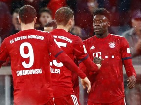 Bayern's Alphonso Davies, right, celebrates after scoring his side's sixth goal during the German Bundesliga soccer match between FC Bayern Munich and 1. FSV Mainz 05 in Munich on Sunday. He strained a ligament during the goal celebration.