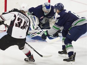 Seattle Thunderbirds Tyrel Bauer watches as Vancouver Giants Evan Patrician's shot is stopped by Seattle goalie Roddy Ross in the second period of Game 2 of their first round playoff series at the Langley Event Centre on Saturday.