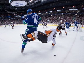 Elias Pettersson and Anaheim Ducks' Sam Steel collide during the first period.