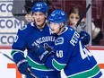 Vancouver Canucks' Bo Horvat, left, and Elias Pettersson, of Sweden, celebrate Horvat's goal against the Los Angeles Kings during the first period of a pre-season NHL hockey game in Vancouver on Thursday September 20, 2018.