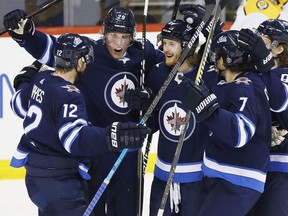 Winnipeg Jets' Kevin Hayes (12), Patrik Laine (29), Kyle Connor (81), Ben Chiarot (7) and Sami Niku (83) celebrate Connor's second goal of the game during third period NHL action against the Nashville Predators, in Winnipeg on Saturday.