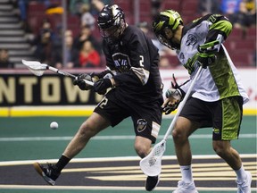 Matt Beers of the Vancouver Warriors, left, and Jeremy Thompson of the Saskatchewan Rush battle for a loose ball in NLL action at Rogers Arena on Jan. 12.