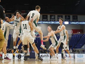Lord Tweedsmuir celebrates winning their semifinal Friday and advancing to Saturday's Quad A boys basketball provincial championship.