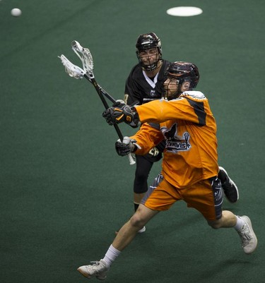 Vancouver Warriors' Dallas Wade (in background) chases after New England Black Wolves' Reilly O'Connor in their regular season National Lacrosse League game at Rogers Arena on Saturday, March 16, 2019.