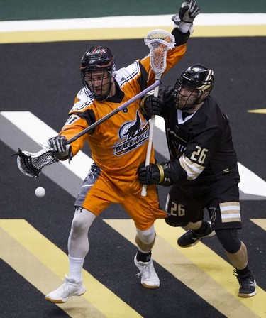 Vancouver Warriors' Zach Porter (right) and New England Black Wolves' Ryan Fournier chase after the ball in their regular season National Lacrosse League game at Rogers Arena on Saturday, March 16, 2019.