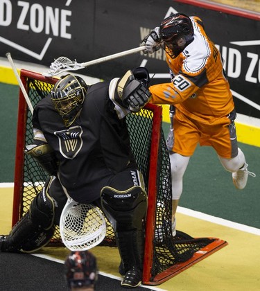 New England Black Wolves Andrew Suitor reaches over the net to score on Vancouver Warriors goalie Eric Penny in their regular season National Lacrosse League game at Rogers Arena on Saturday, March 16, 2019.