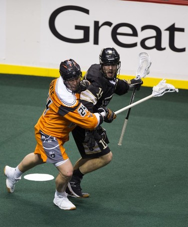 Vancouver Warriors' Jean-Luc Chetner (right) keeps the ball from New England Black Wolves' Joel Coyle in their regular season National Lacrosse League game at Rogers Arena on Saturday, March 16, 2019.