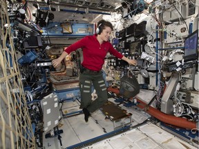 Flight Engineer Anne McClain looks at a laptop computer screen inside the U.S. Destiny laboratory module of the International Space Station on Jan. 18, 2019, in a photo made available by NASA.