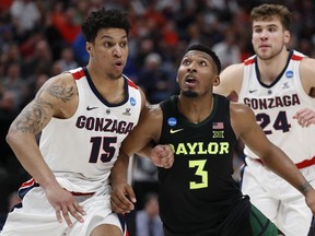 Gonzaga forward Brandon Clarke, left, and Baylor guard King McClure work for position during the second half of a second-round game in the NCAA men's college basketball tournament Saturday, March 23, 2019, in Salt Lake City.