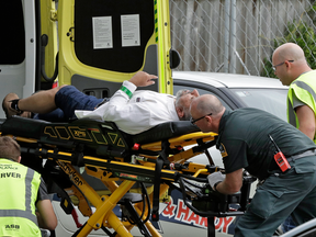 Ambulance staff remove a man from outside a mosque in Christchurch, New Zealand, March 15, 2019.