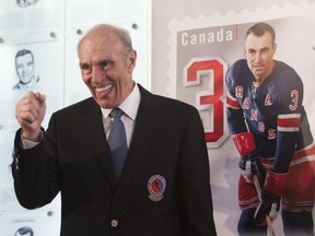 New York Rangers legend Harry Howell reacts during the unveiling of the NHL stamp series featuring the Original Six defencemen at the Hockey Hall of Fame in Toronto on Oct. 2, 2014.