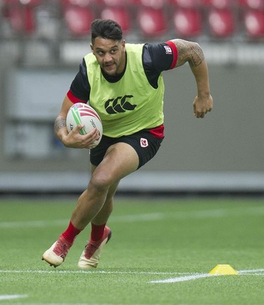 Team Canada's Mike Fuailefau runs in a drill during practice at B.C. Place Stadium on Wednesday. His team’s HSBC Canada Sevens tournament kicks off Saturday morning against Samoa, Fuailefau’s father’s homeland.