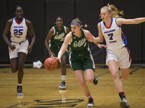 Walnut Grove's Tavia Rowell dribbles the ball past Semiahmoo's Faith Dut (#25) and Tara Wallack (#7) in the finals of the B.C. Secondary Schools Girls AAA Basketball Championships at the Langley Events Centre. The Semiahmoo Totems are the provincial champions with a 72-61 victory.